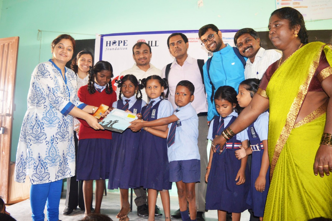 JLL CSR team awarding Hope foundation children