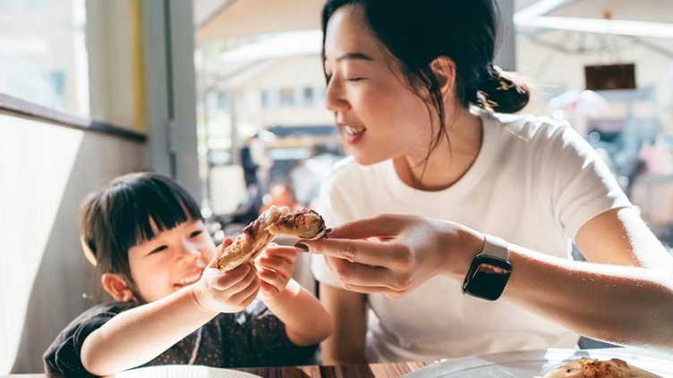 young lady with her kid having snacks