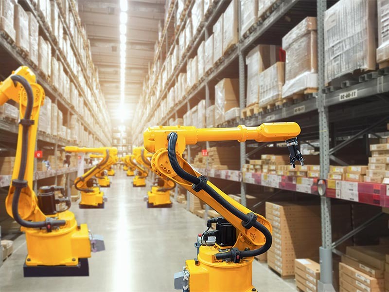 Automatic robot mechanical arm is working in temporary storage in a distribution warehouse.