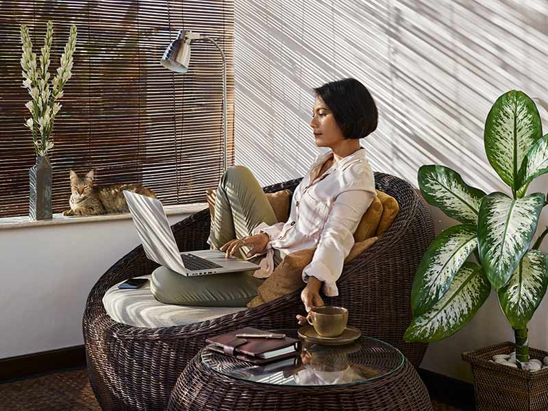 women working on laptop at her residence