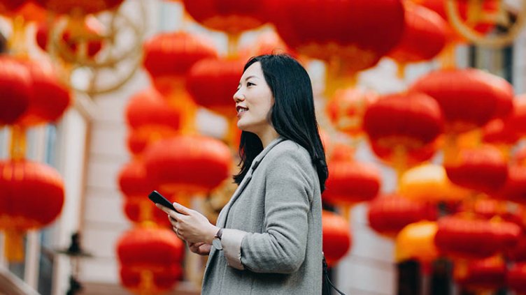 Women standing with a mobile