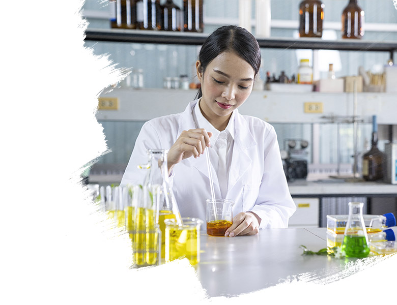 A lab specialist using a beaker and doing a test. 