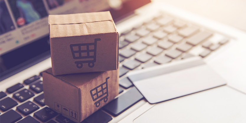 Shopping online concept - Shopping service on The online web. with payment by credit card and offers home delivery. parcel or Paper cartons with a shopping cart logo on a laptop keyboard