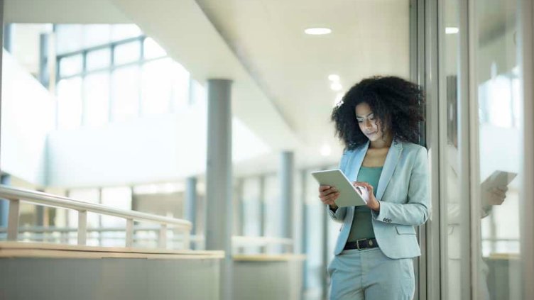 Woman using tablet inside the JLL office building