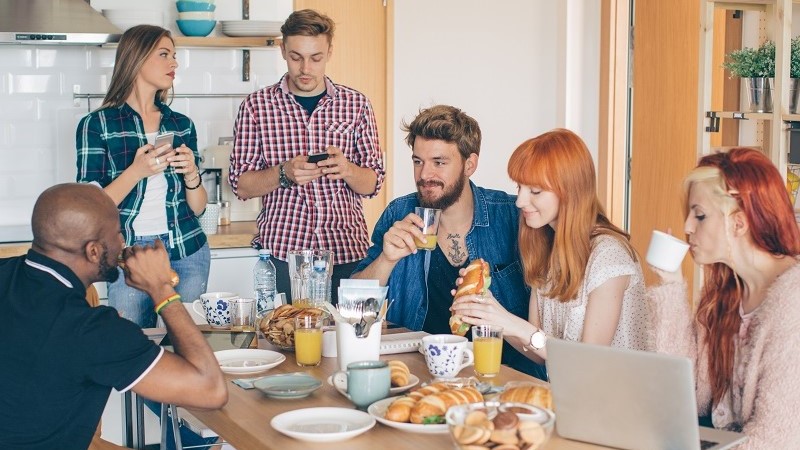 Peoples having breakfast in coliving apartment 