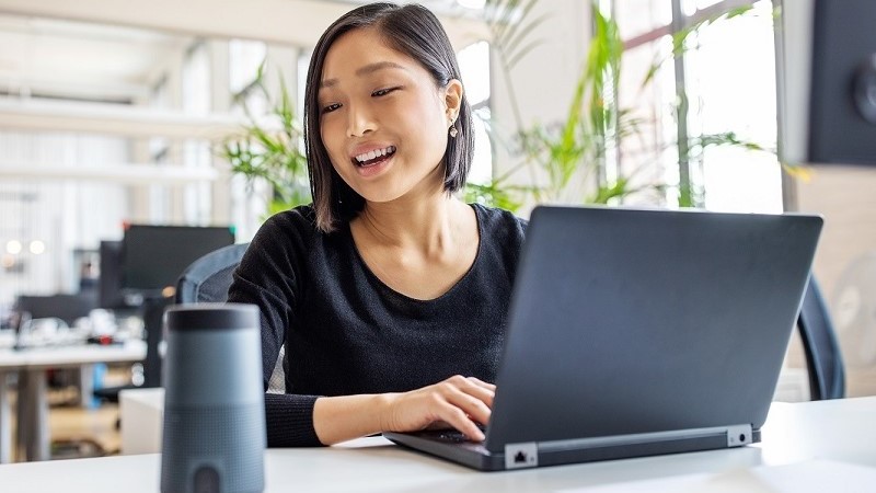 A female employee working on her laptop inside the JLL office