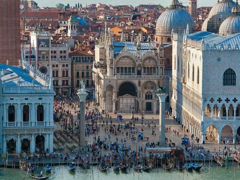 Elevated view of people and gondolas in St. Mark's Square Venice
