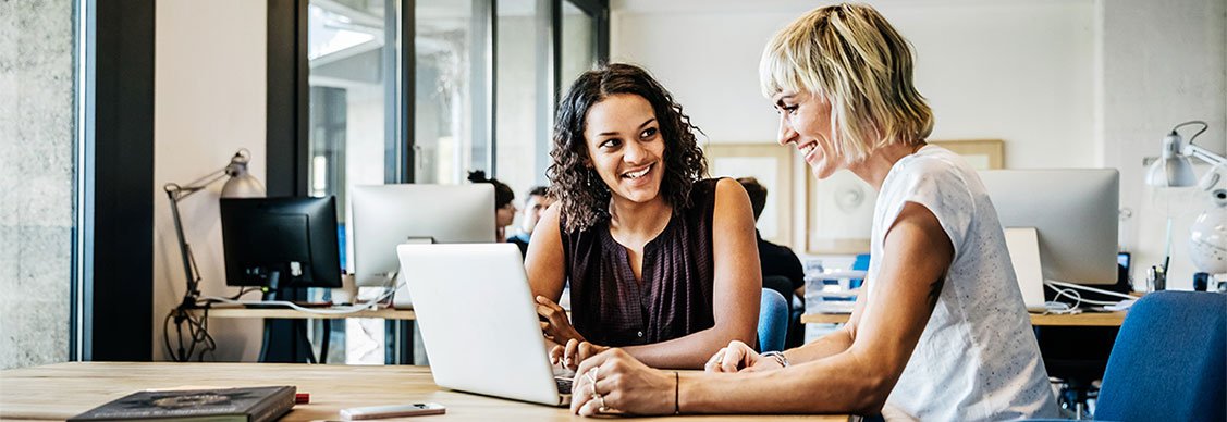 Two woman looking at laptop