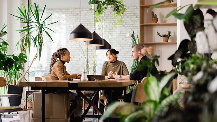 Employees having a discussion on the project details in the coworking office space