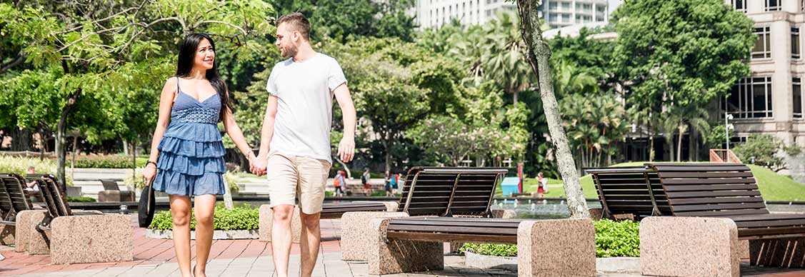 A couple is walking holding hands