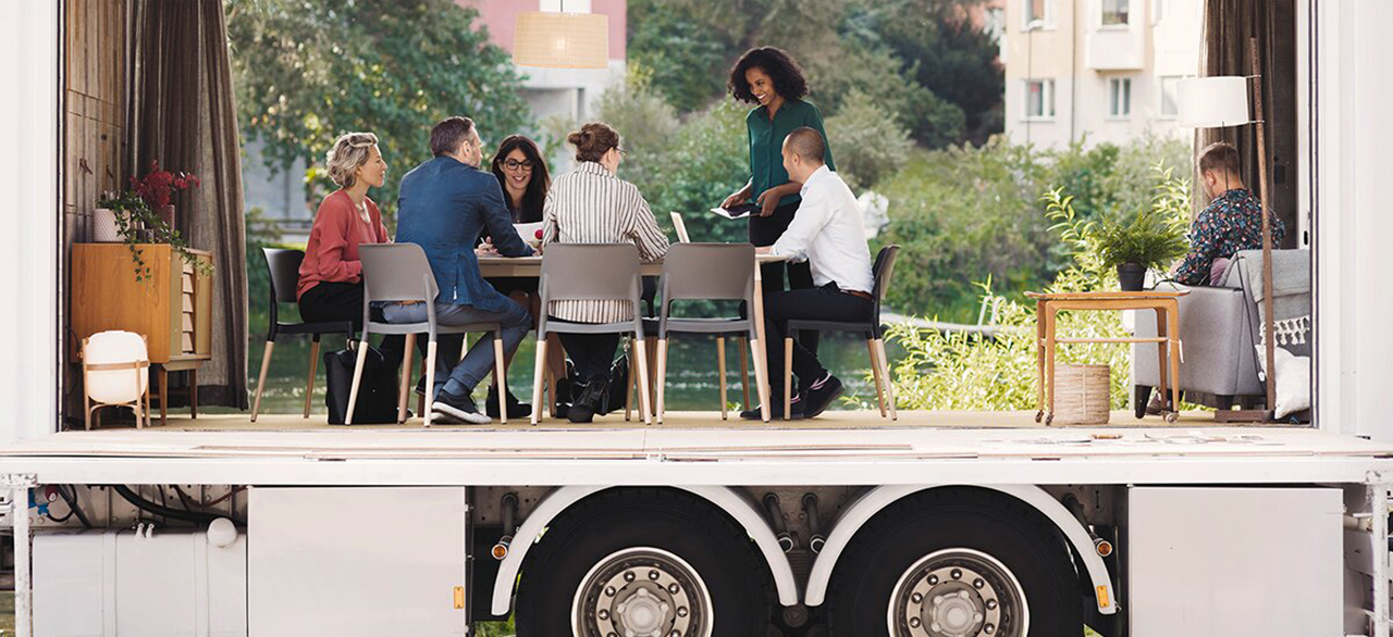 business collegues discussing in portable office truck at park in the city